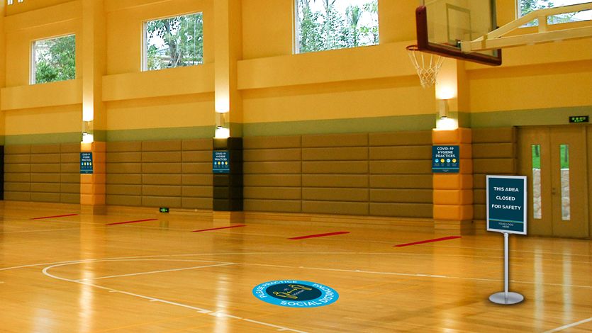 School Gym with COVID-19 Hygiene Signs